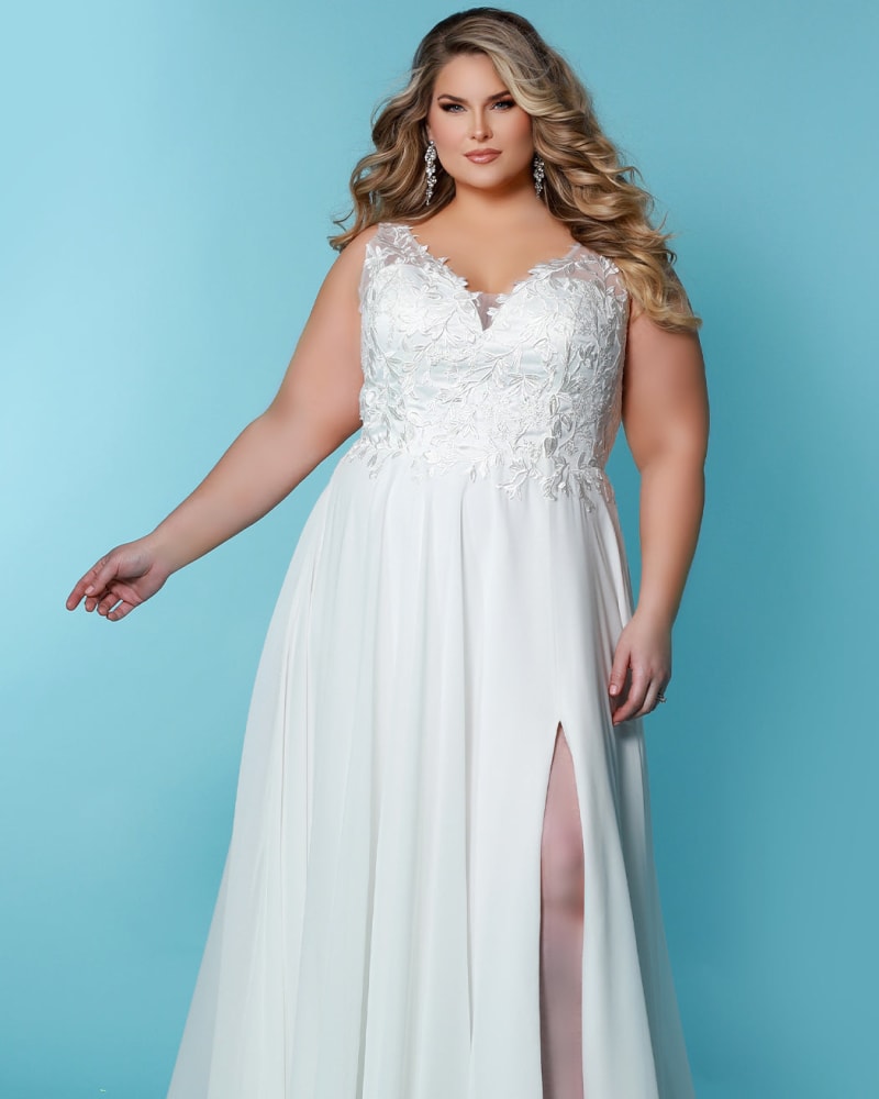 Front of a model wearing a size 24 Theodora Wedding Dress in Ivory by Sydney's Closet. | dia_product_style_image_id:286724